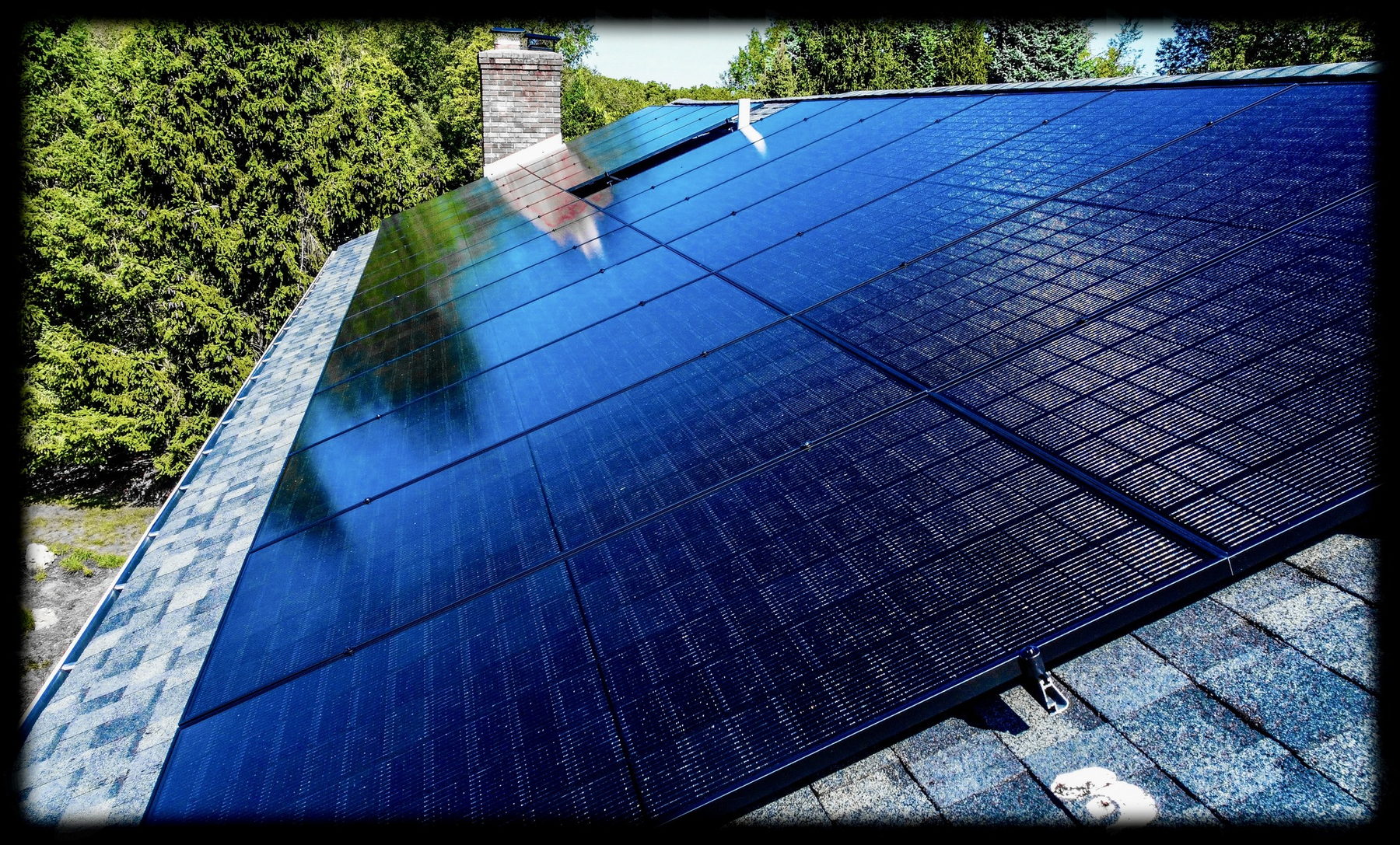 Close-up of sleek all-black solar panels installed on a residential roof